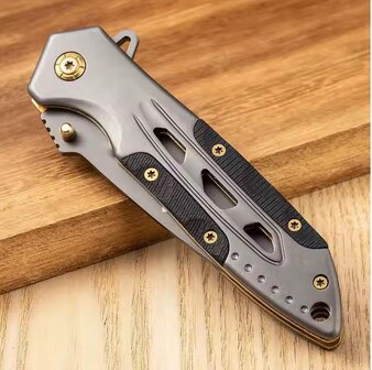 Zakmes met Titanium coating  en gouden tinden.
